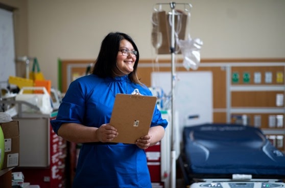 medical student near IV stand and gurney