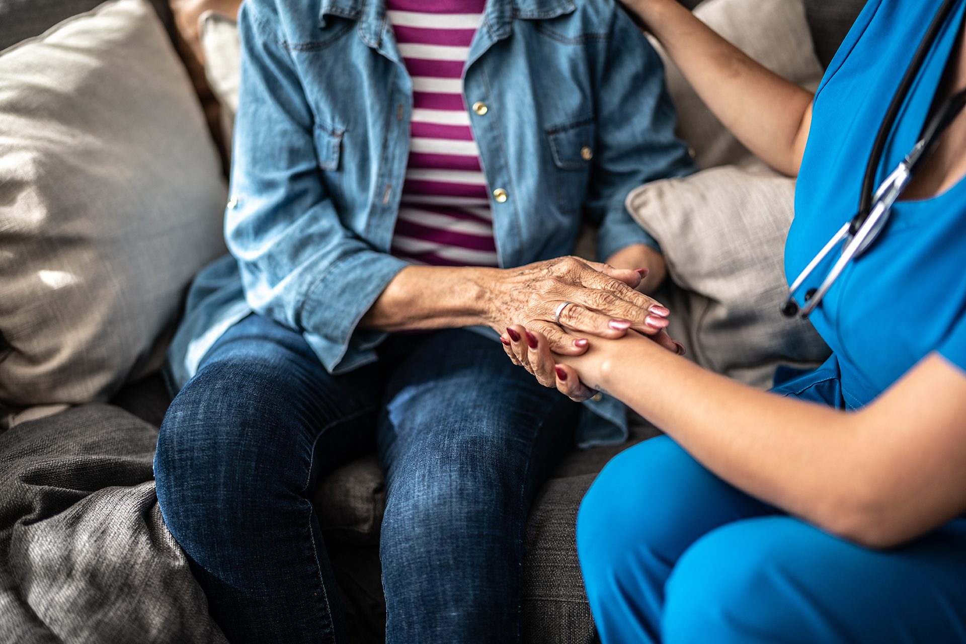 Person holding hands with an older adult