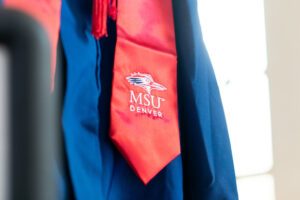 A picture of a cap and gown, zoomed in on the red regalia