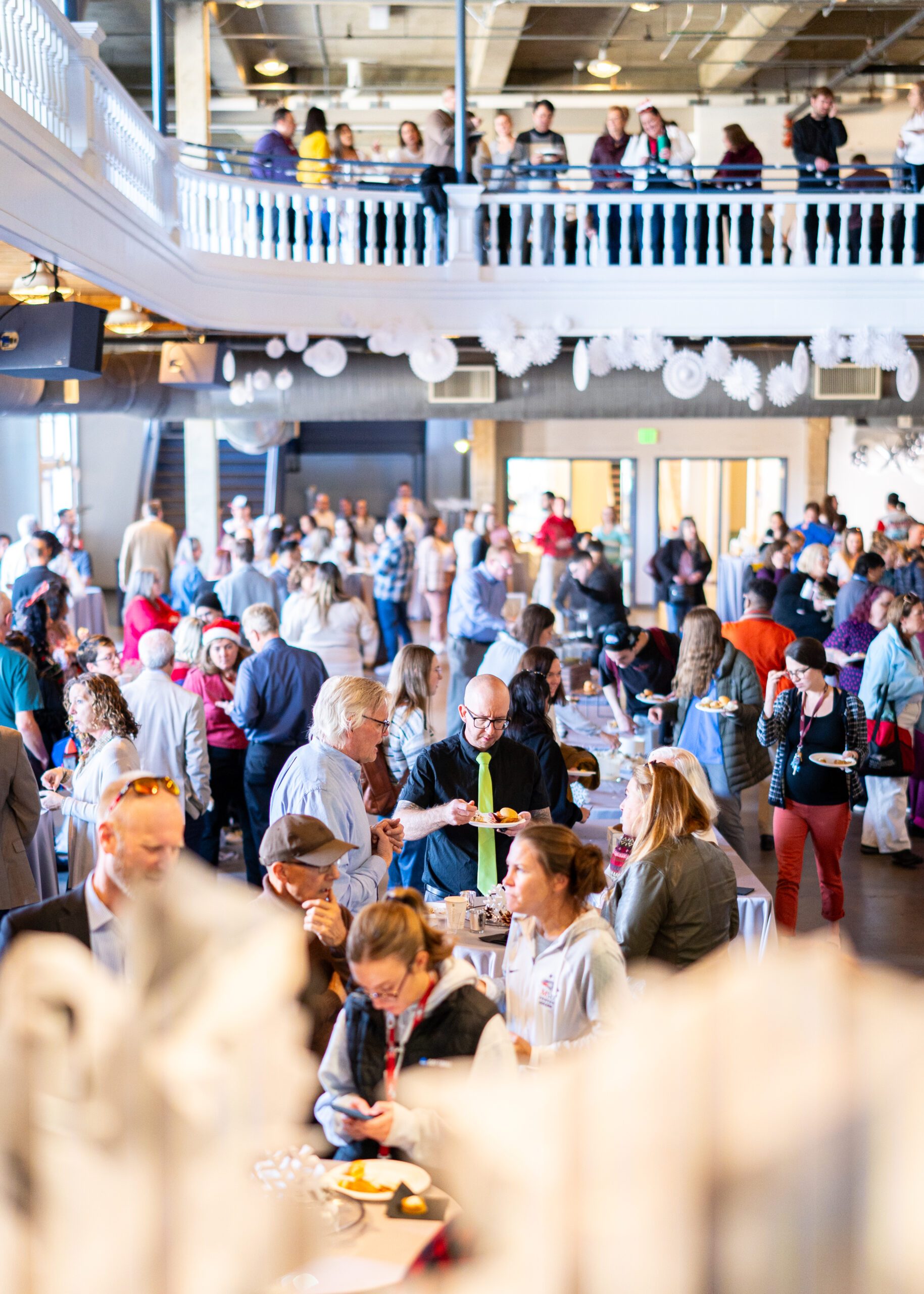 A large crowd of guests mingling at the annual Staff and Faculty Holidayfest