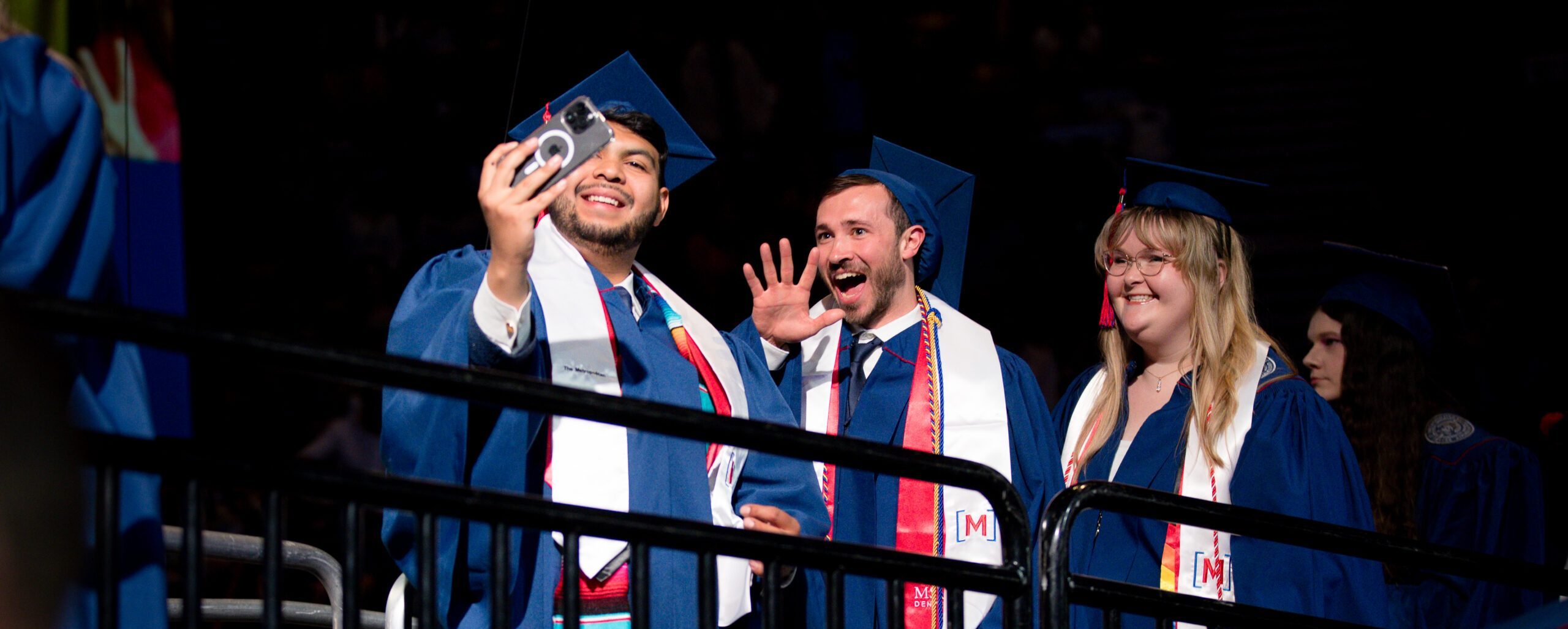 Grads take a celebratory selfie before they cross the stage at Commencement