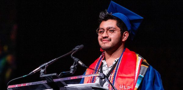 President's Award Winner, Gaberiel Trujillo, stands at the podium, addressing his classmates at Commencement