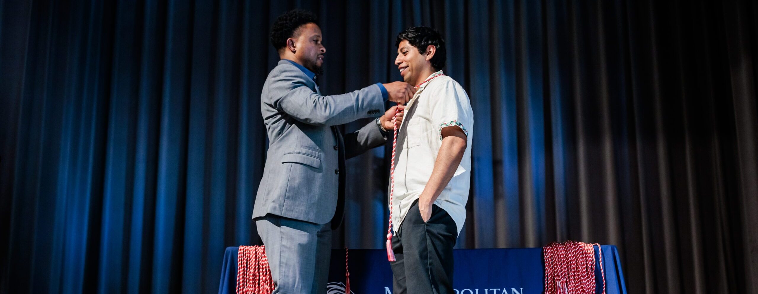 A graduate receives their First Gen cords at the First Gen Specialty Graduation Celebration.