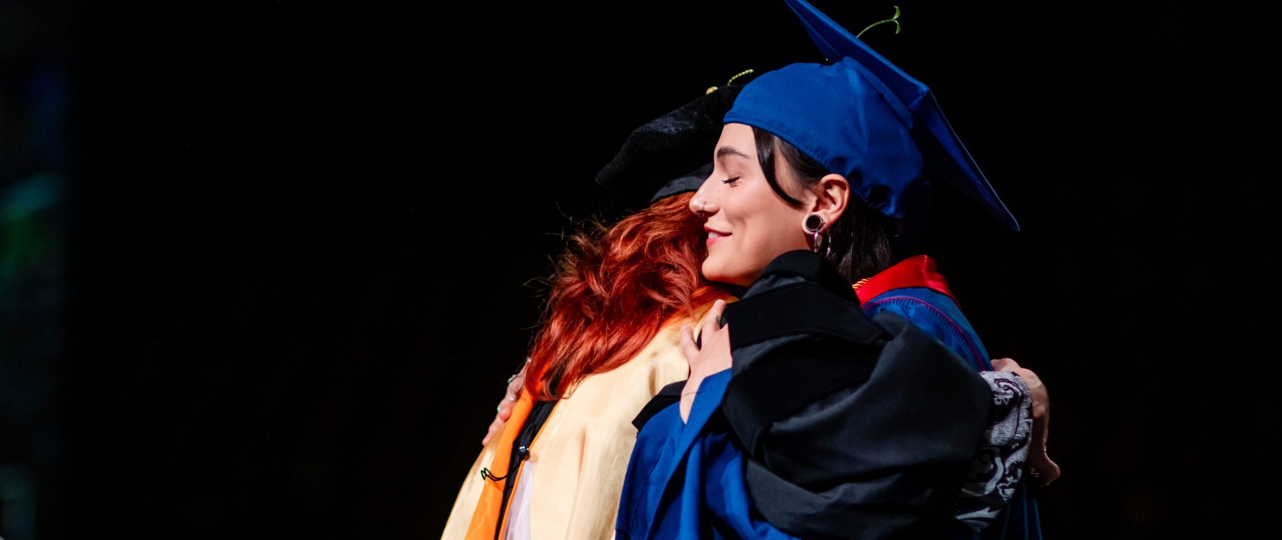 Provost's Award winner, Valeria Pernas, hugs her dean, Hope Sypulski, before giver her speech at Commencement.