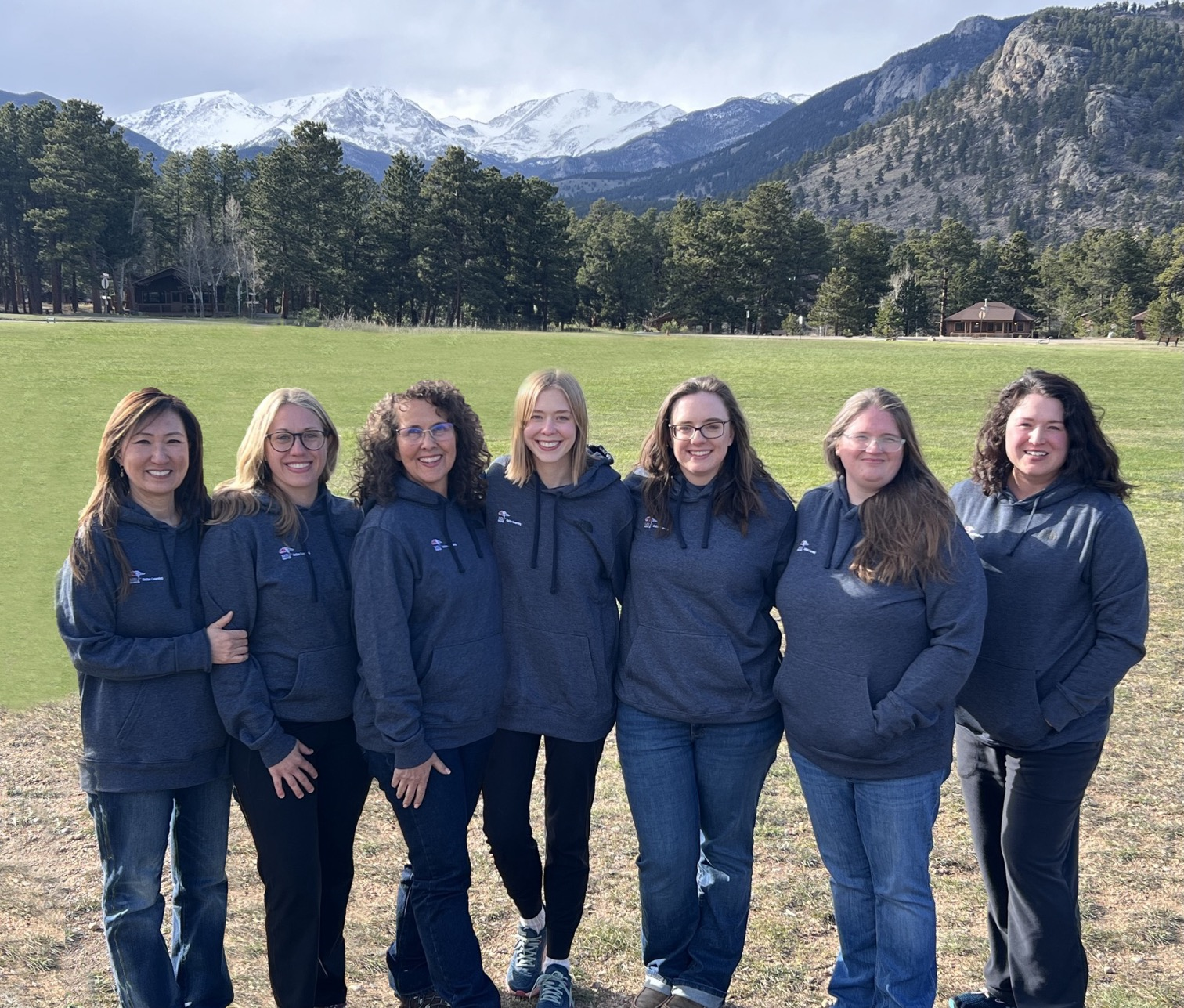 Online learning team photo with rocky mountains backdrop