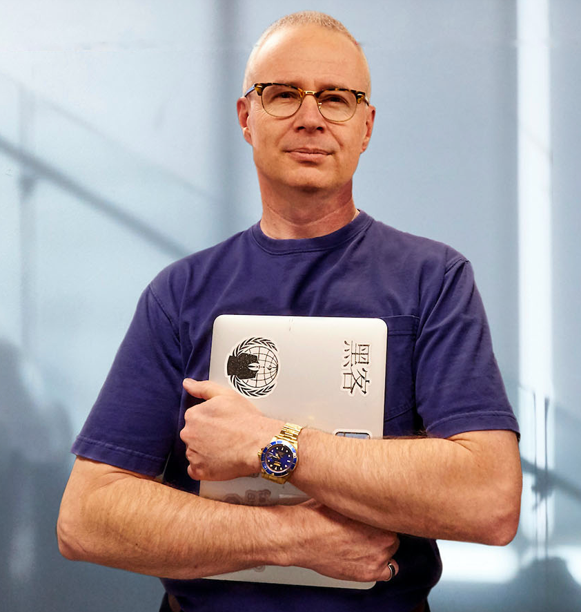 College of Aerospace, Computing, Engineering, and Design Interim Dean, Steve Beaty headshot with laptop in hands