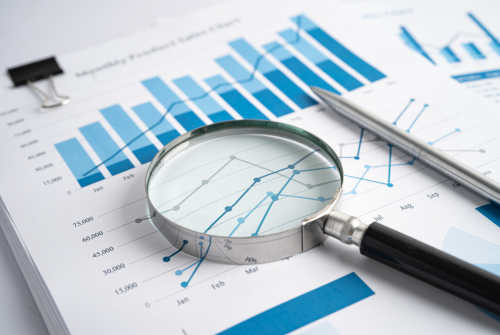 Magnifying glass resting on top of financial report