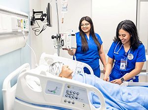 MSU Denver Nursing students Marisa Schreiner, left, and Jimena Malta Zuniga prepare for an IV medication administration using an infusion pump at the Simulation and Skills Laboratory. Photo by Alyson McClaran