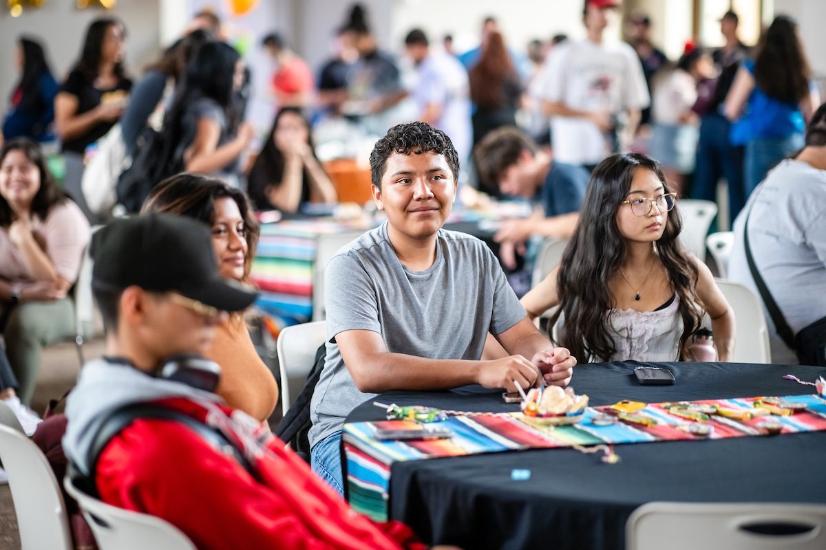 Students sitting and smiling at an event