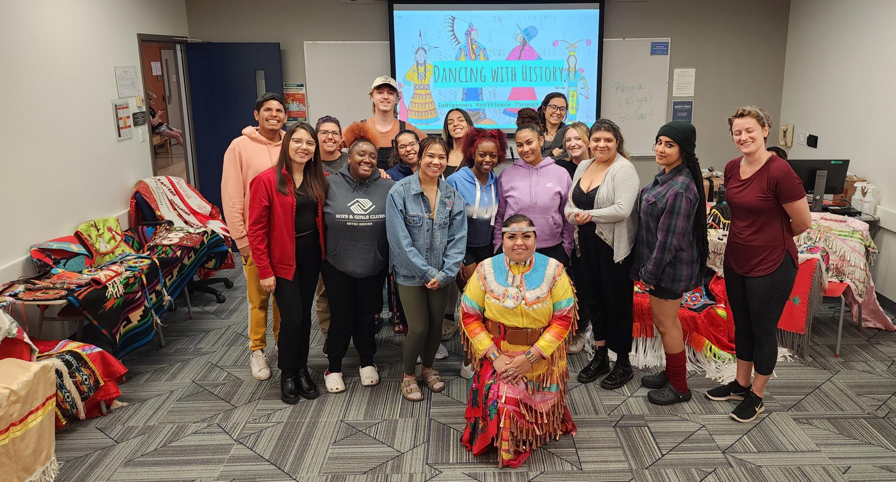 Group of Students pose for a photo at an Indigenous Dance educational event.