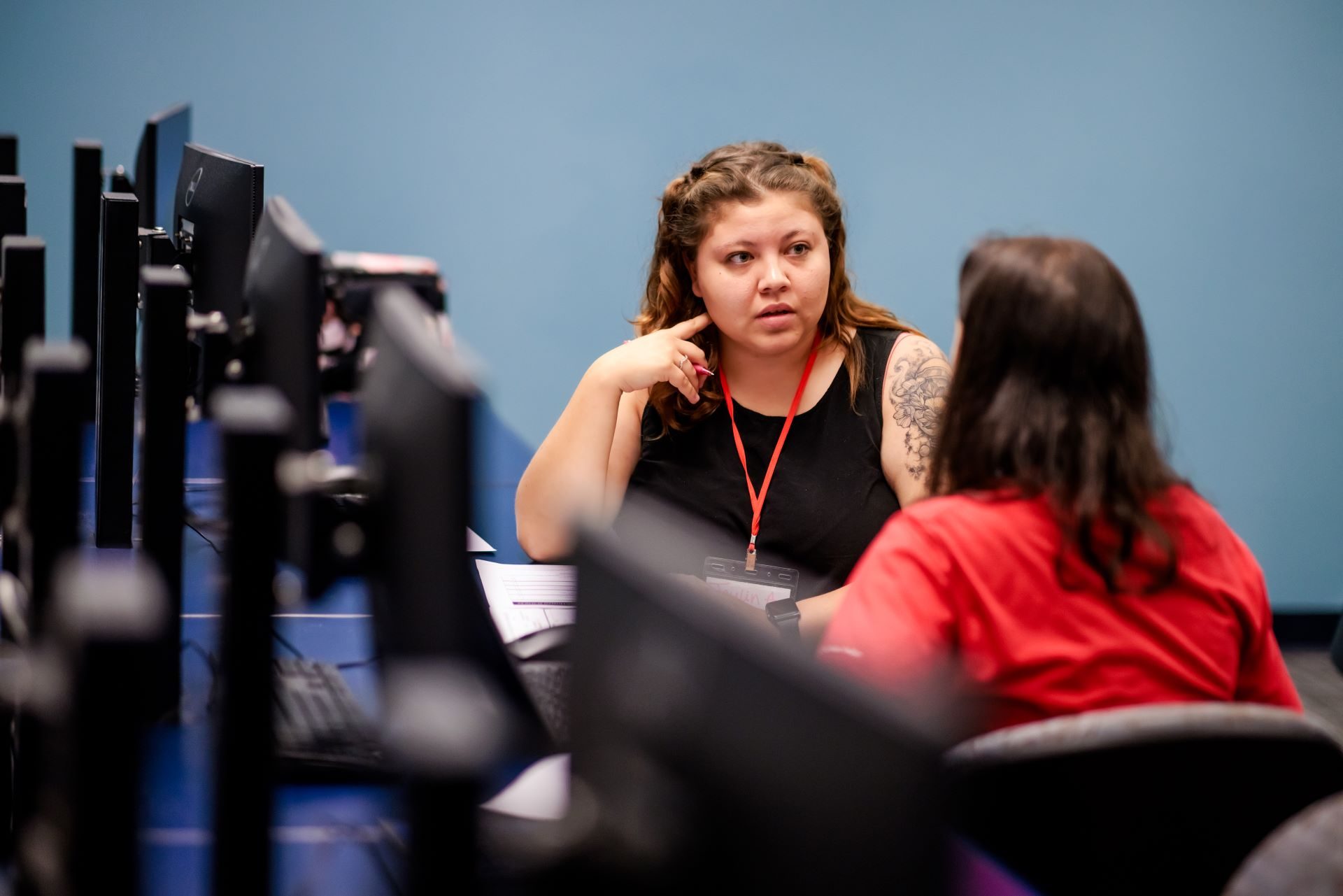 Two people talking in a computer lab