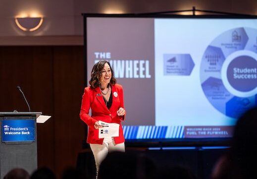 President Davidson stands in front of a PowerPoint slide containing an image of 