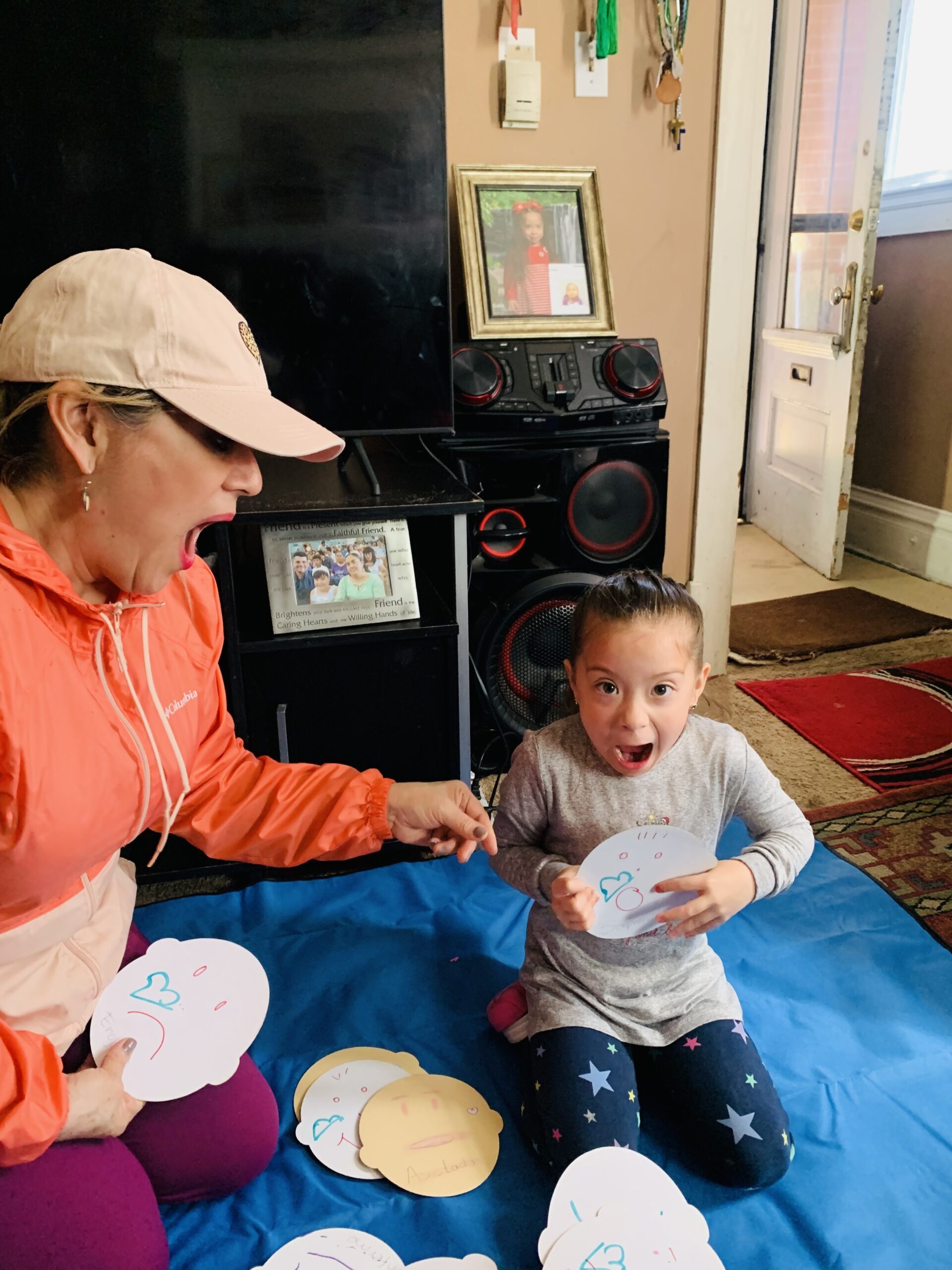 A parent and a child during a home visit making silly faces