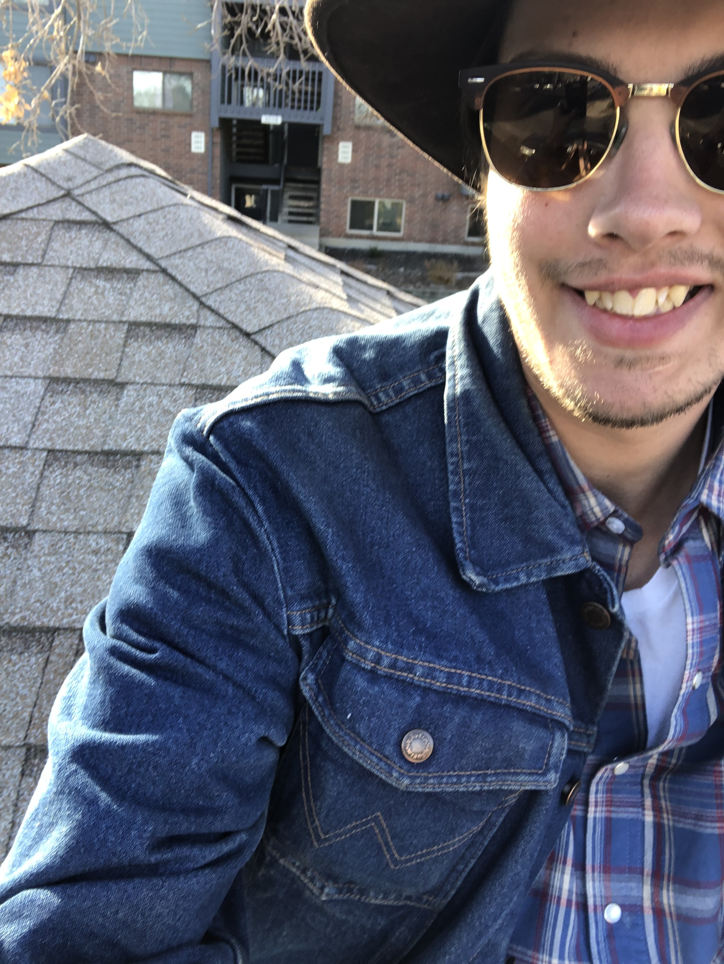 Ben Brown smiling on a rooftop