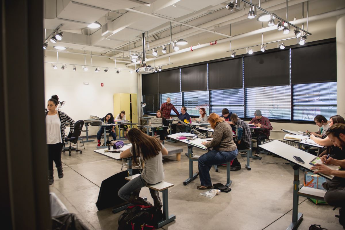 Students in a classroom drawing individually on easels