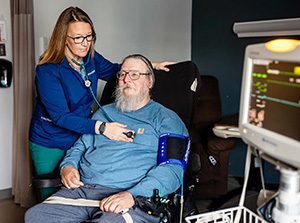 MSU Denver alumna Jessie Cochran listens to the heart and lungs of resident Barry Dee at Haxtun Health Hospital on Nov. 18, 2024, in Haxtun, Colorado. Photo by Alyson McClaran