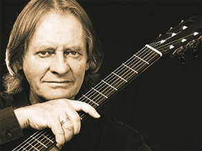 Headshot of David Russell with guitar