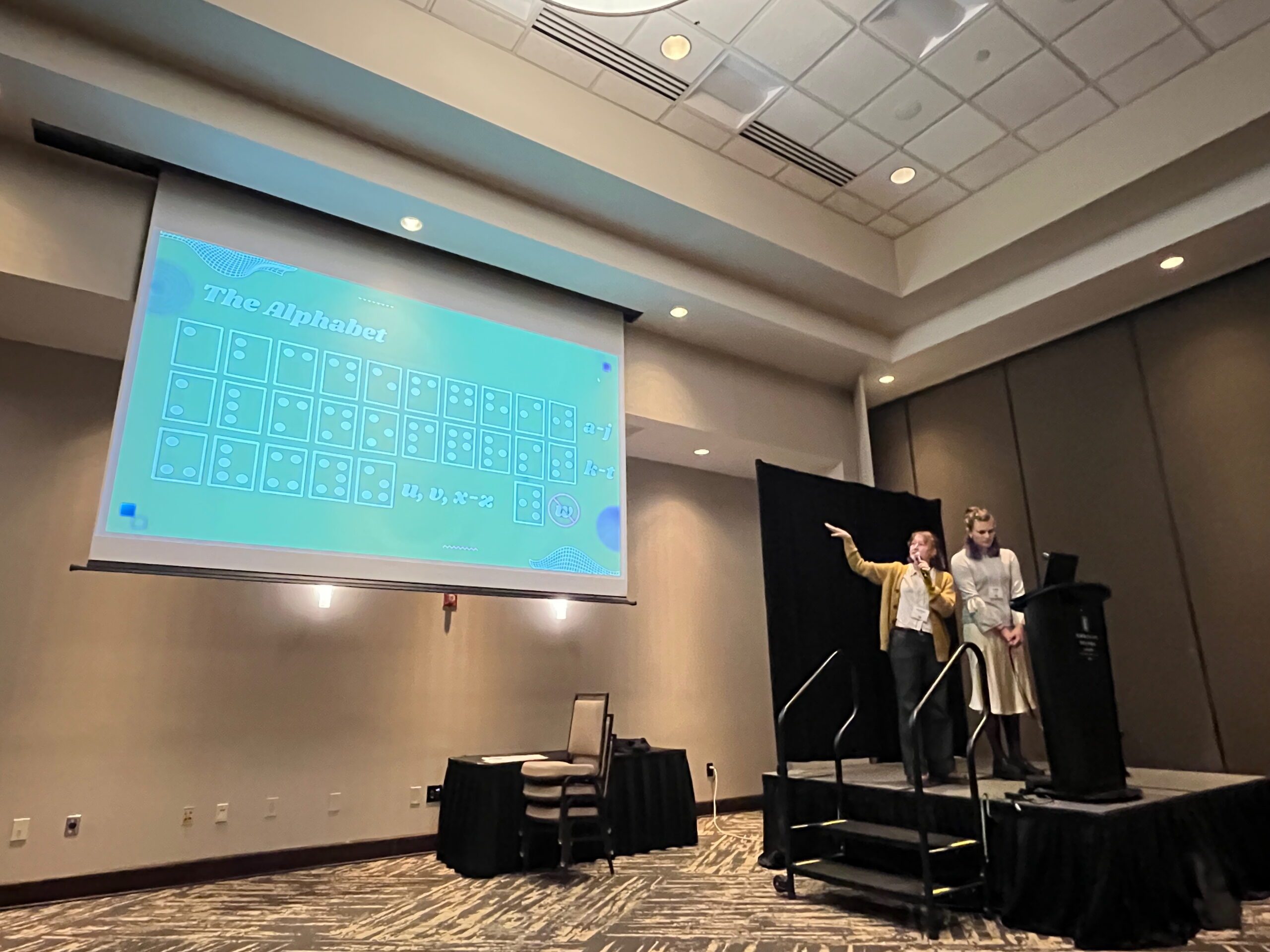 Two MSU math students, Matilyn and Violet, give a talk on their research at the 2025 Nebraska Conference for Undergraduate Women in Mathematics