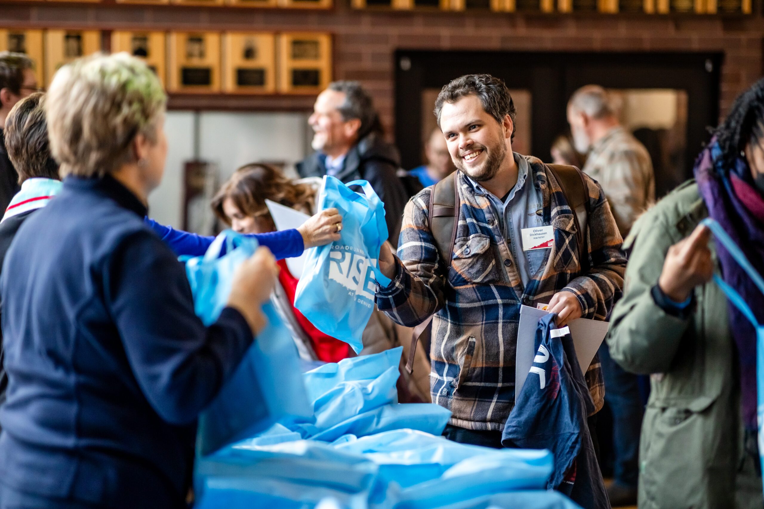 Guests receiving free gifts at Roadrunners Rise Campaign Launch event