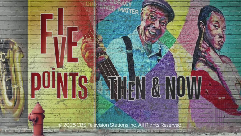 A colorful mural painted on a brick wall featuring the words 'Five Points' in bold red text and 'Then & Now' in black text. The mural includes images of a saxophone, a red fire hydrant, an older Black man smiling while playing a guitar, and a young Black woman in a red outfit gazing confidently at the viewer.