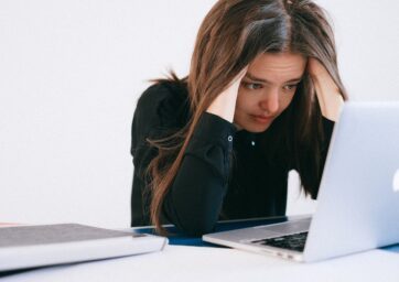 Stressed person staring at laptop screen